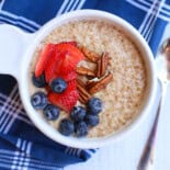 Instant pot steel cut oats with sliced strawberries, blueberries, and chopped pecans on top.