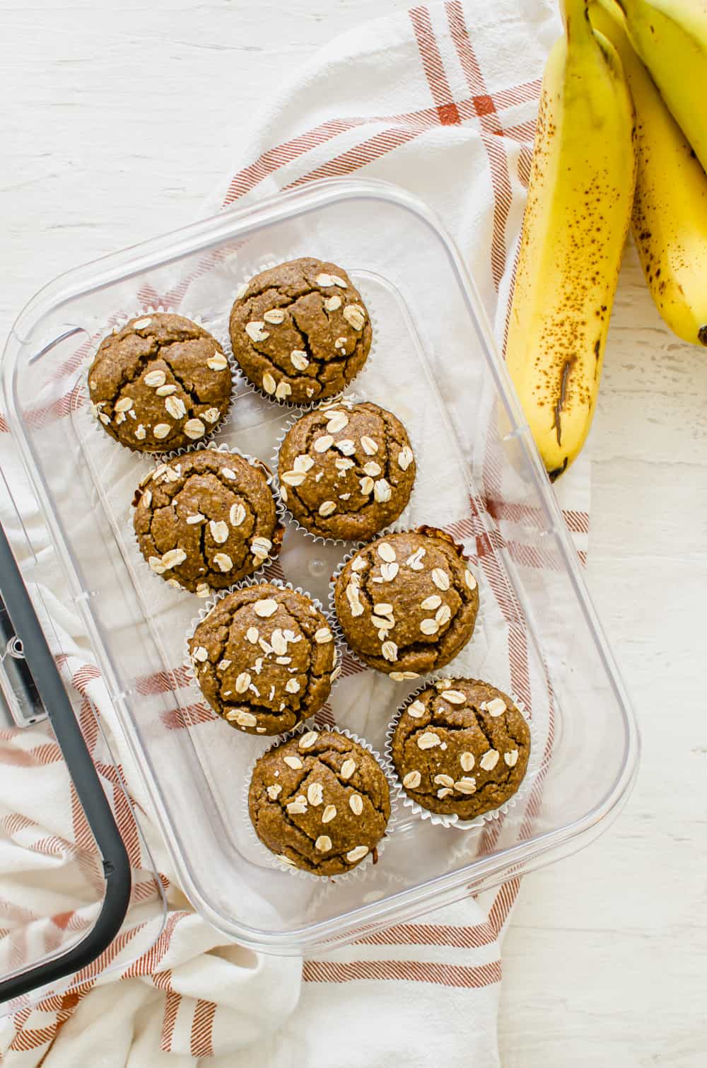 Gluten-free banana muffins in a freezer-safe container ready for the freezer.