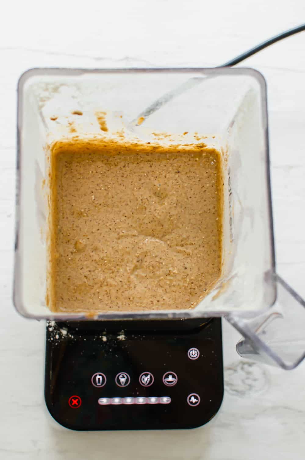 Gluten-free banana muffin ingredients blended up in a blender.