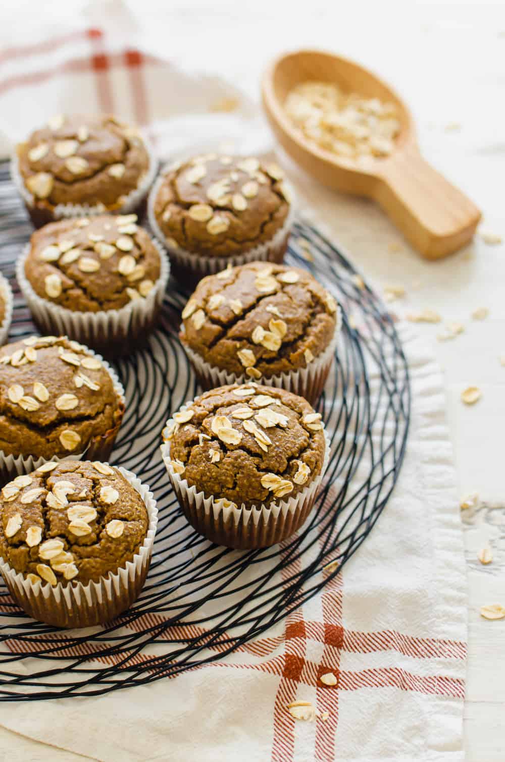 Gluten-free banana muffins with oats on top lined up on a wire platter.