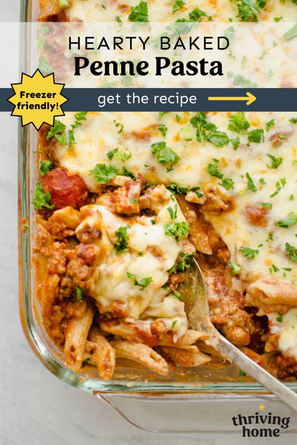 Baked penne pasta in a casserole dish being spooned out.