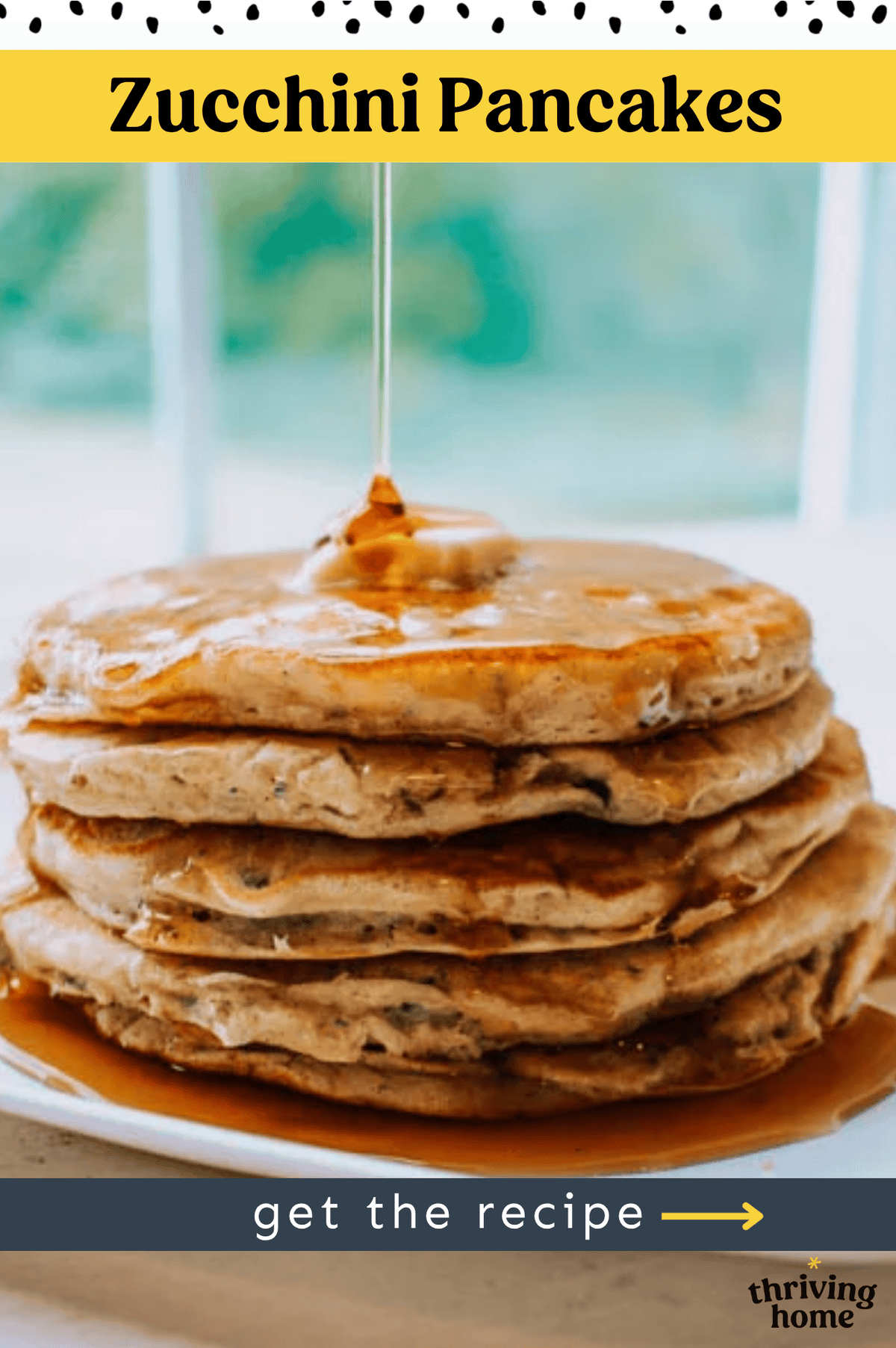 Zucchini pancakes stacked up on a white plate with maple syrup pouring down.