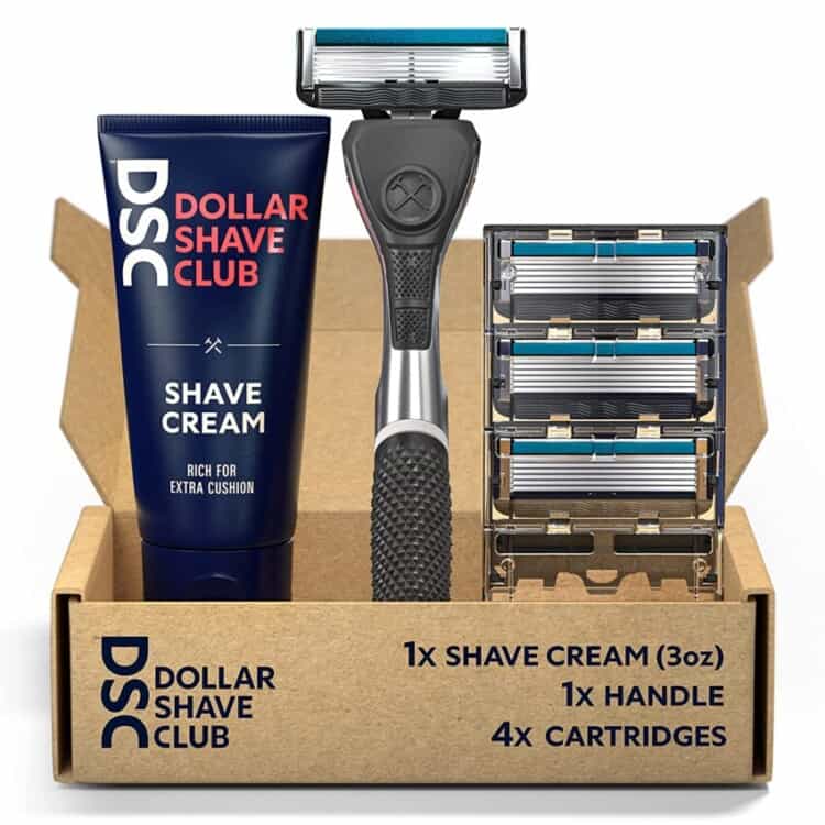Brown box that says Dollar Shave Club with a tube of shaving cream, razor, and refillable cartridges.