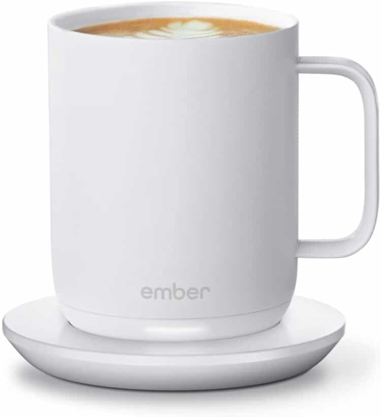 A white 'smart coffee mug' on it's warmer that keeps your drink perfectly hot for 1.5 hours.