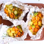 Grilled vegetables in foil packs ready to eat.