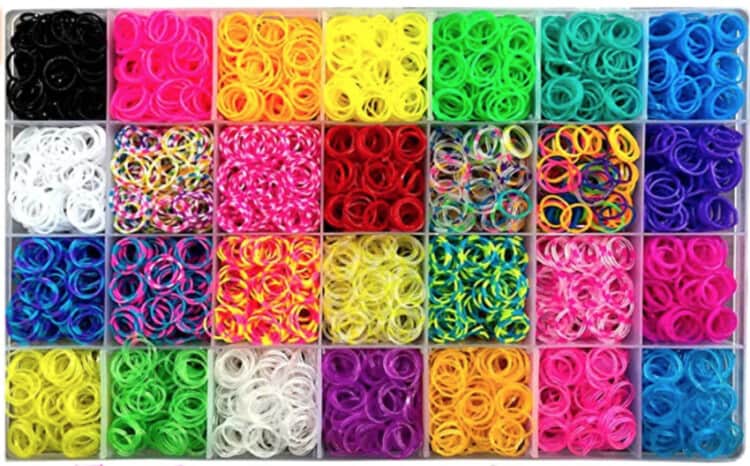 Photo of a clear plastic organizer holding many color of small rubber bands to be used in loom-band crafts.