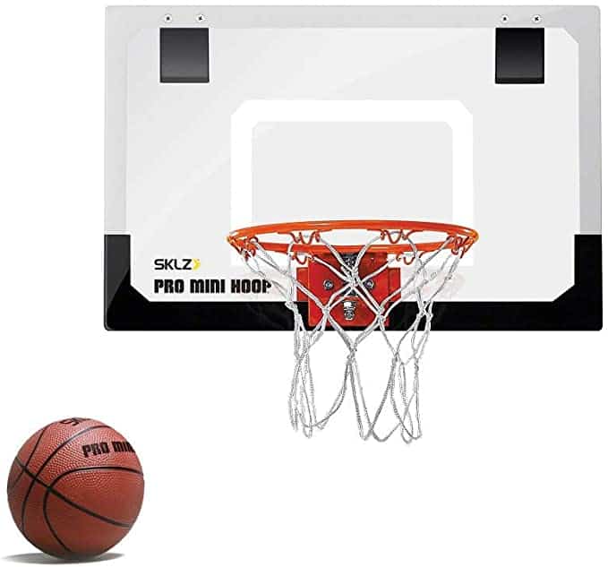 Stock photo of an over-the-door mini basketball hoop with a small basketball next to it.