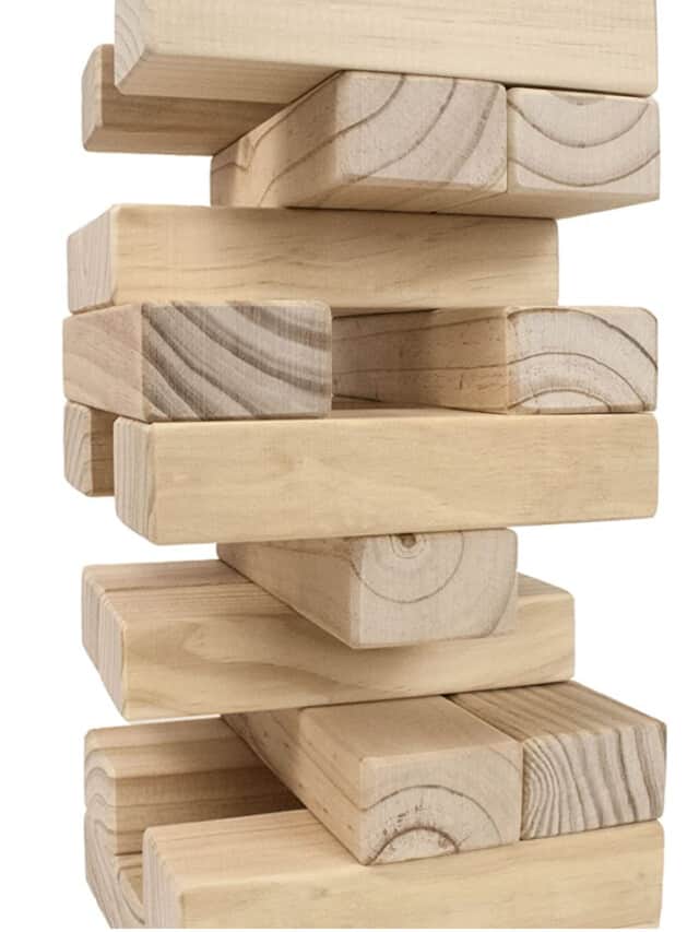 Large wooden pieces stacked to play outdoor Jenga.