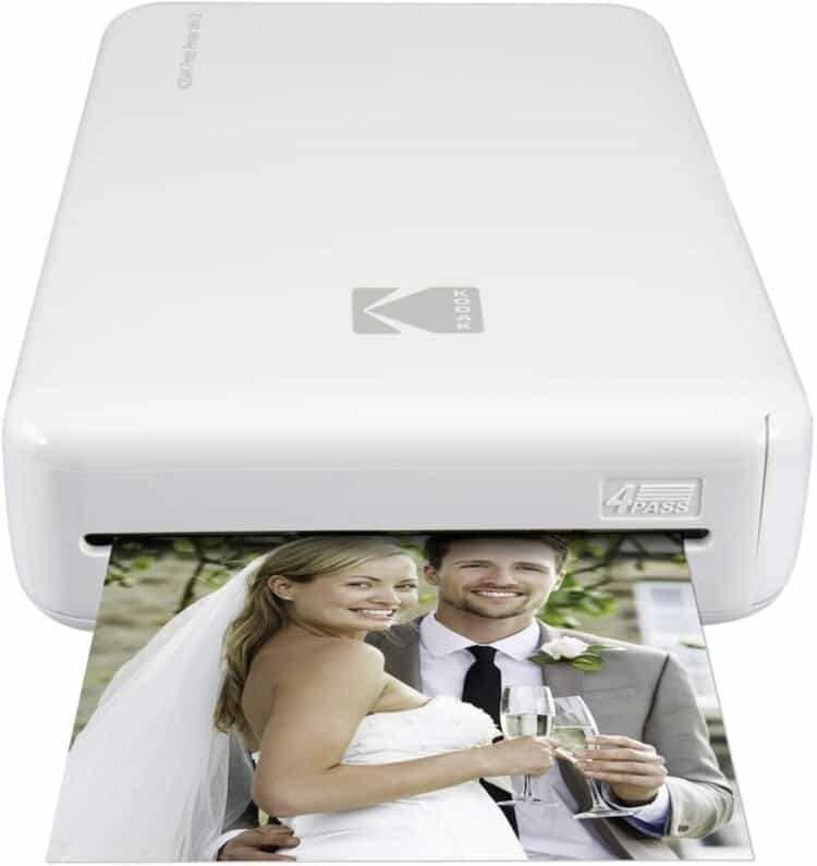 Small, rectangular photo printer that prints 4x6 photos and has a wedding photo coming out of it.