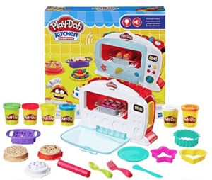 Stock photo of Play-Doh kitchen box with all the pieces set out in front of it.