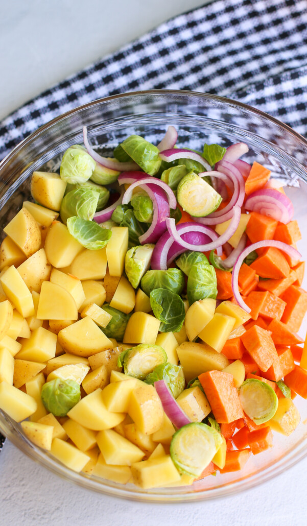 A glass bowl full of diced vegetables 