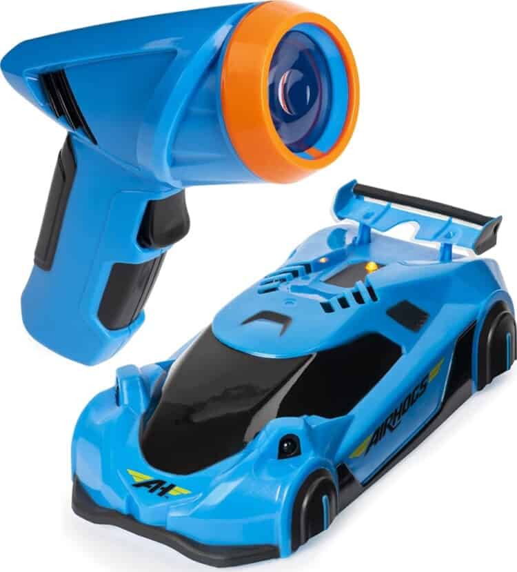 Blue remote control car with a remote control laser next to it.
