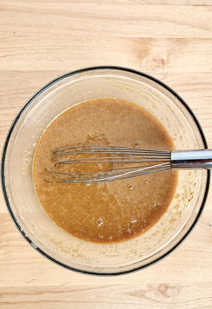 wet ingredients for applesauce bread in a glass bowl