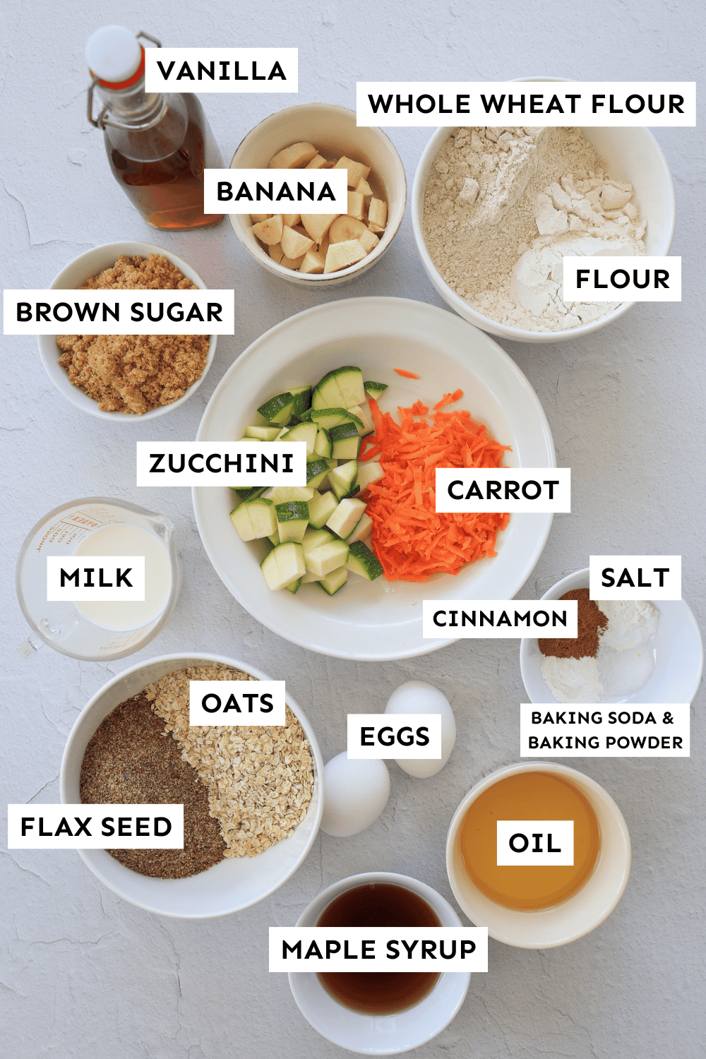 Ingredients for zucchini carrot muffins measured out in bowls. 