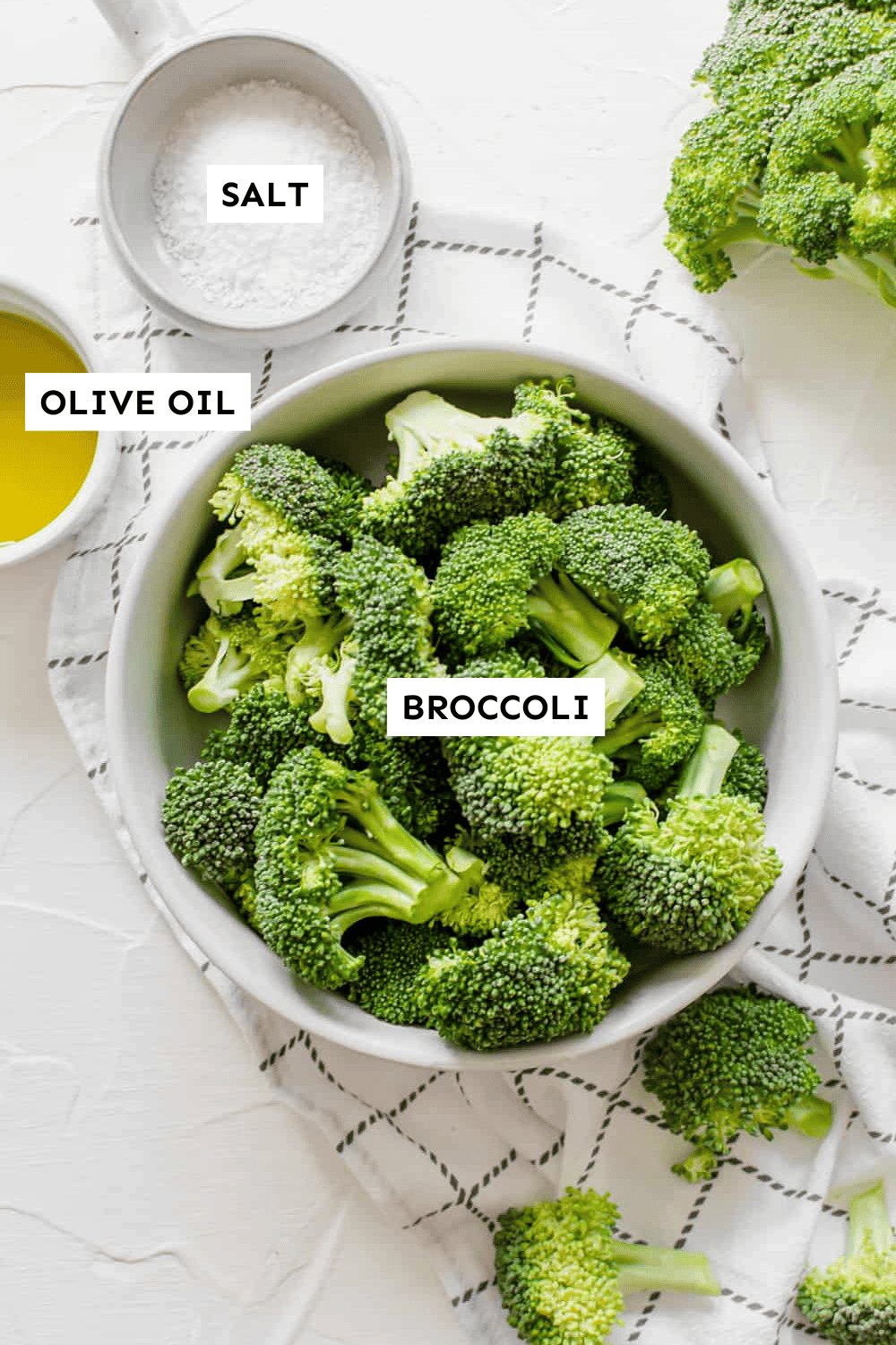 Ingredients for oven roasted broccoli laid out and labeled.