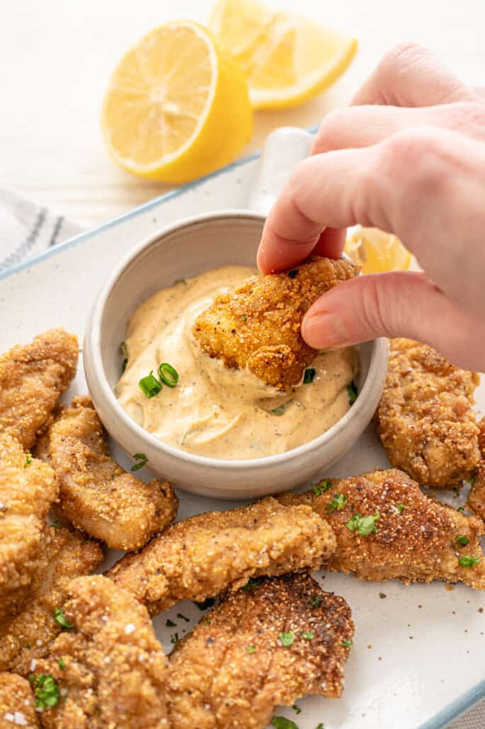 a catfish nugget being dipped