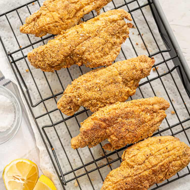 Fried catfish on a wire rack.