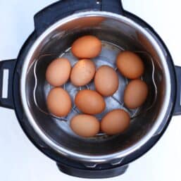 Brown eggs on a rack inside an Instant Pot.