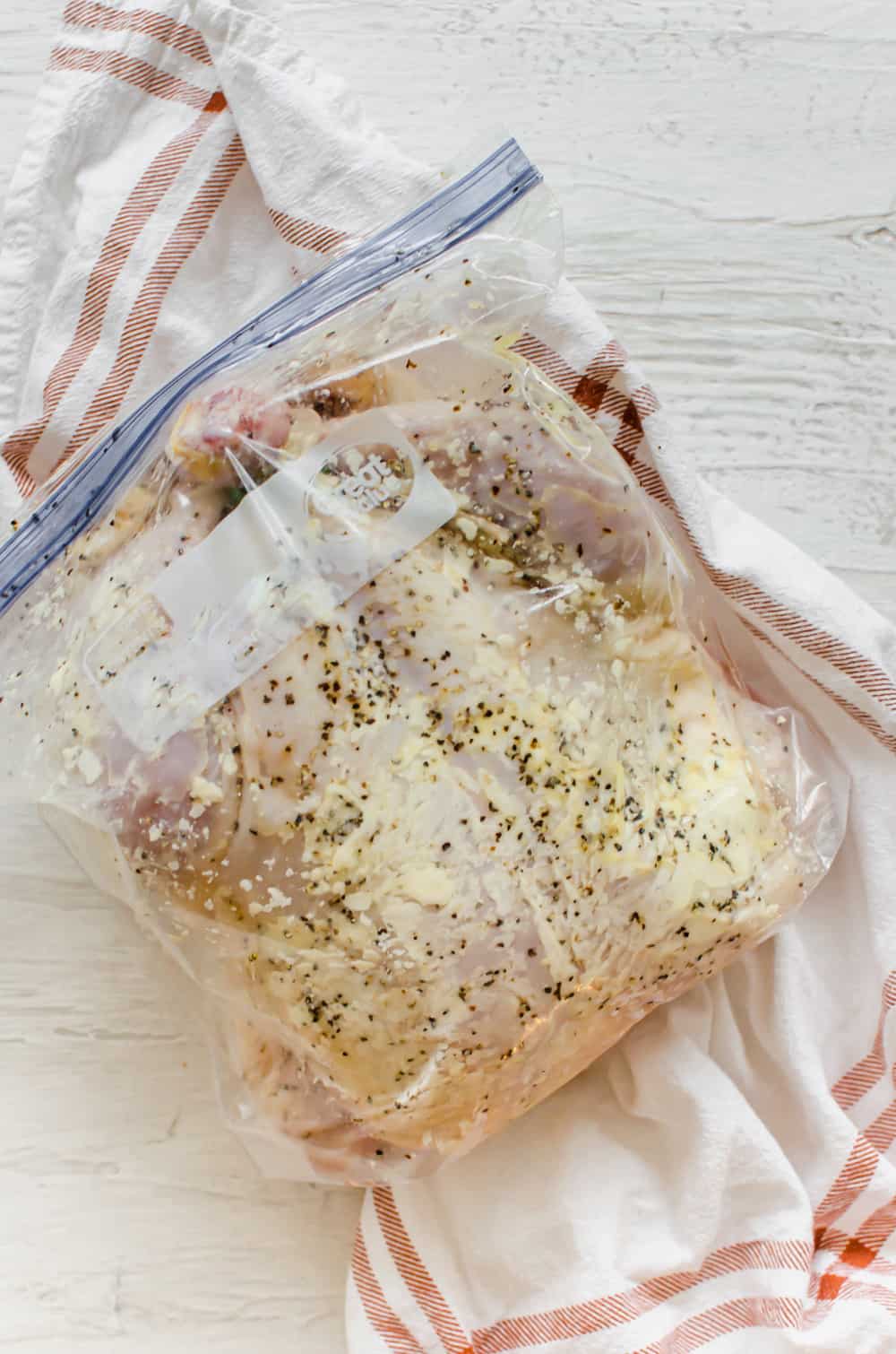 Frozen whole chicken in a freezer bag.
