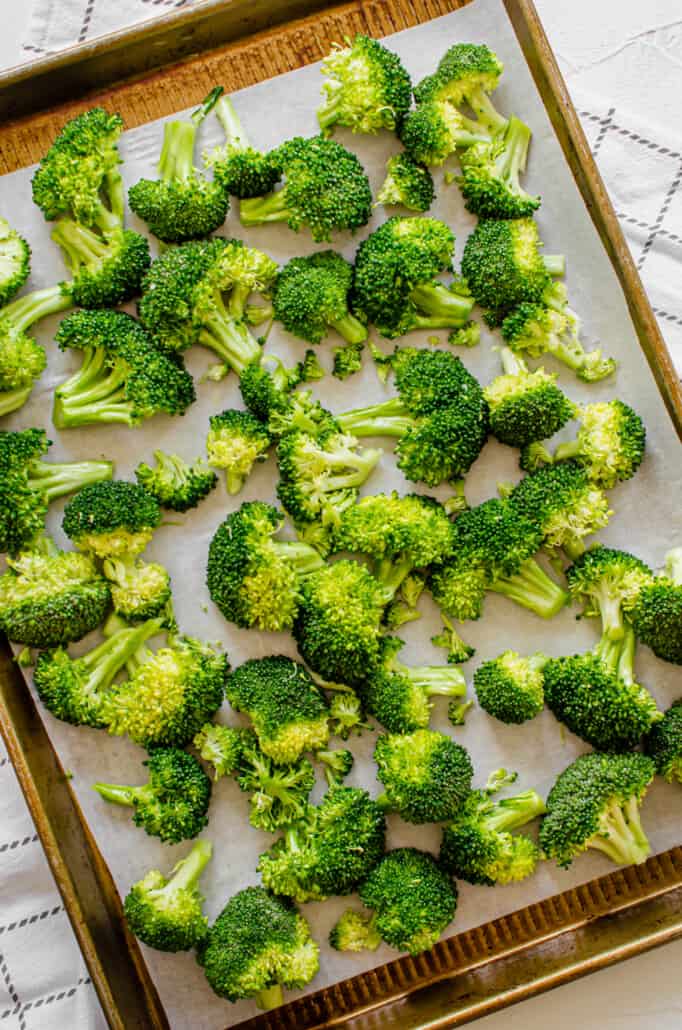 Broccoli spread out on a baking sheet