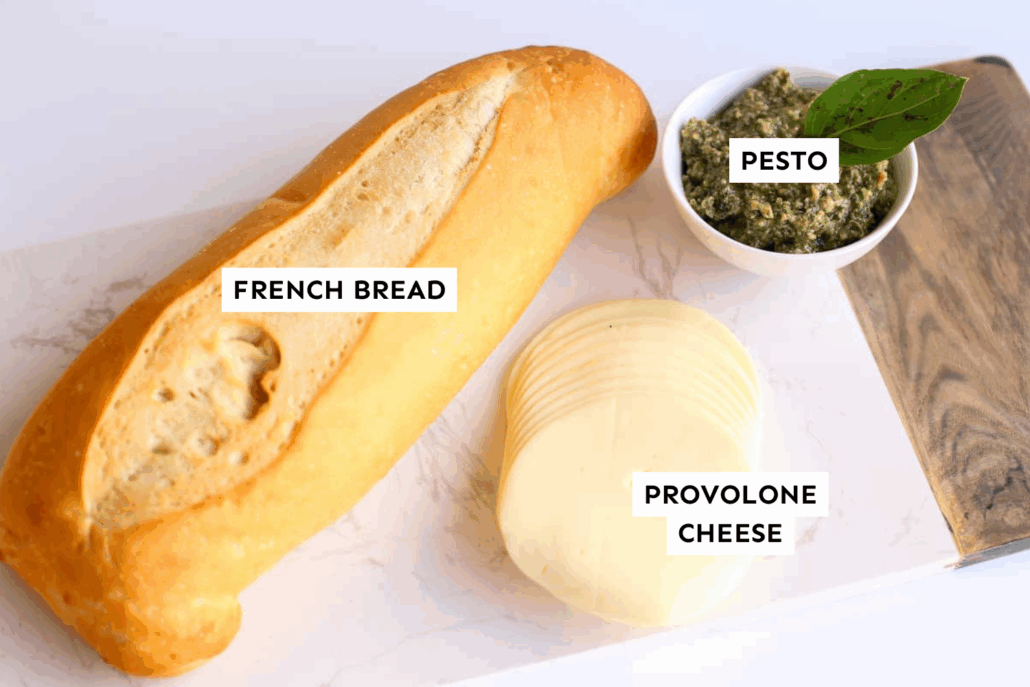 Ingredients for cheesy bread laid out on a counter and labeled.