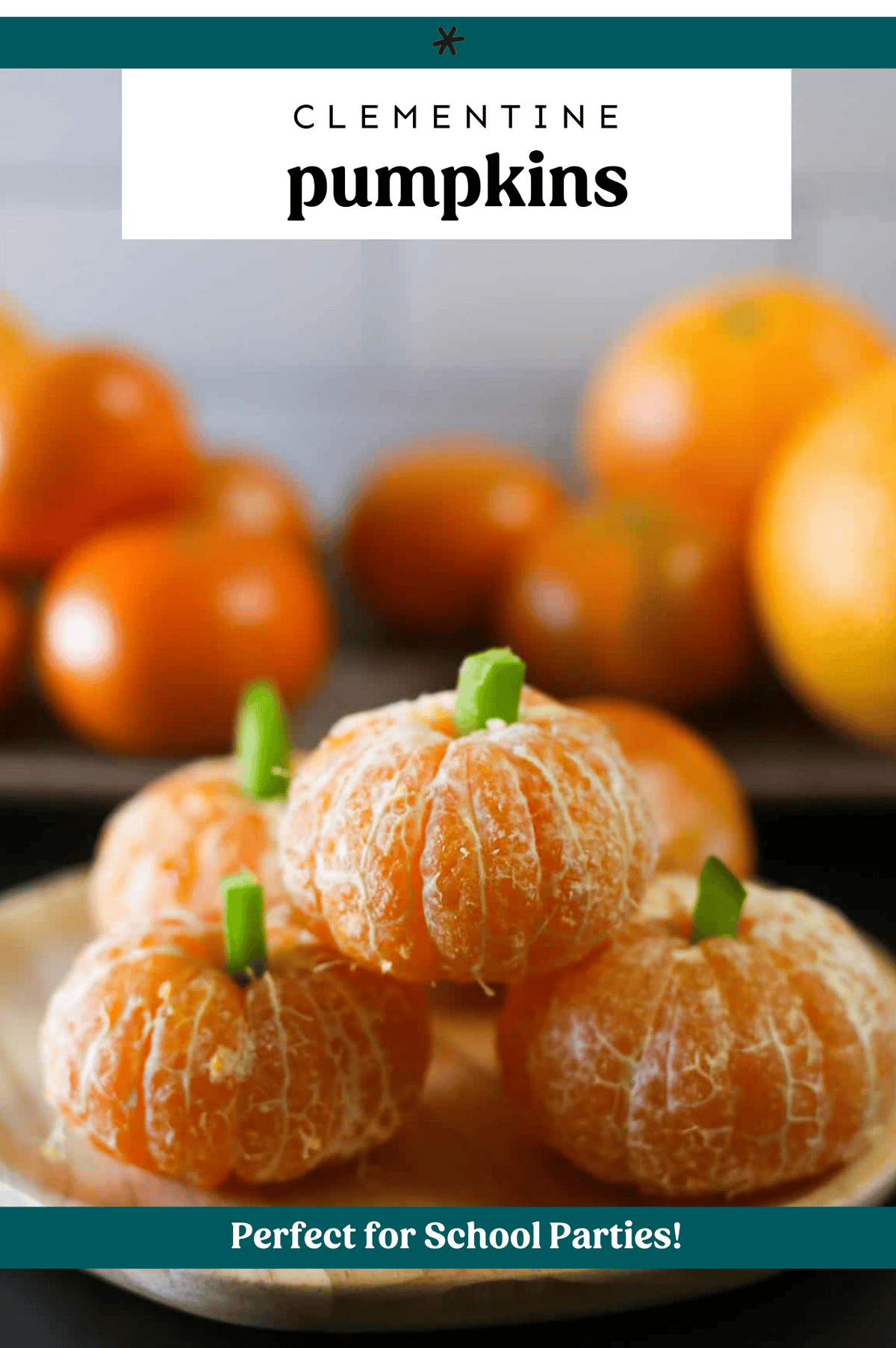 Peeled clementines stacked up with small pieces of a green pepper to look like stems.