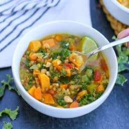 Coconut Curry Soup in a bowl with a spoon.