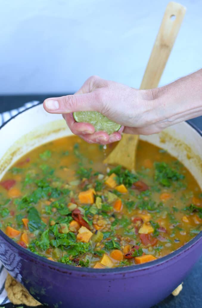 squeezing lime juice into vegetable soup