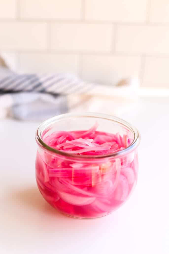 pickled red onions in a jar