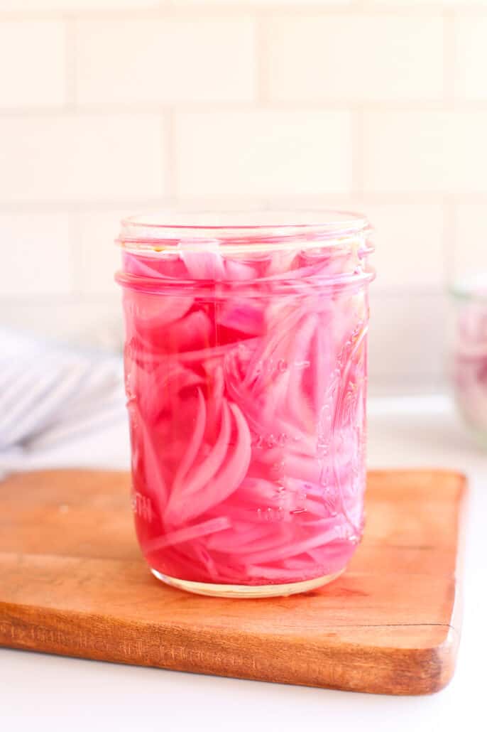 pickled red onions in a mason jar