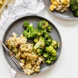 A plate with chicken stuffing casserole and roasted broccoli.
