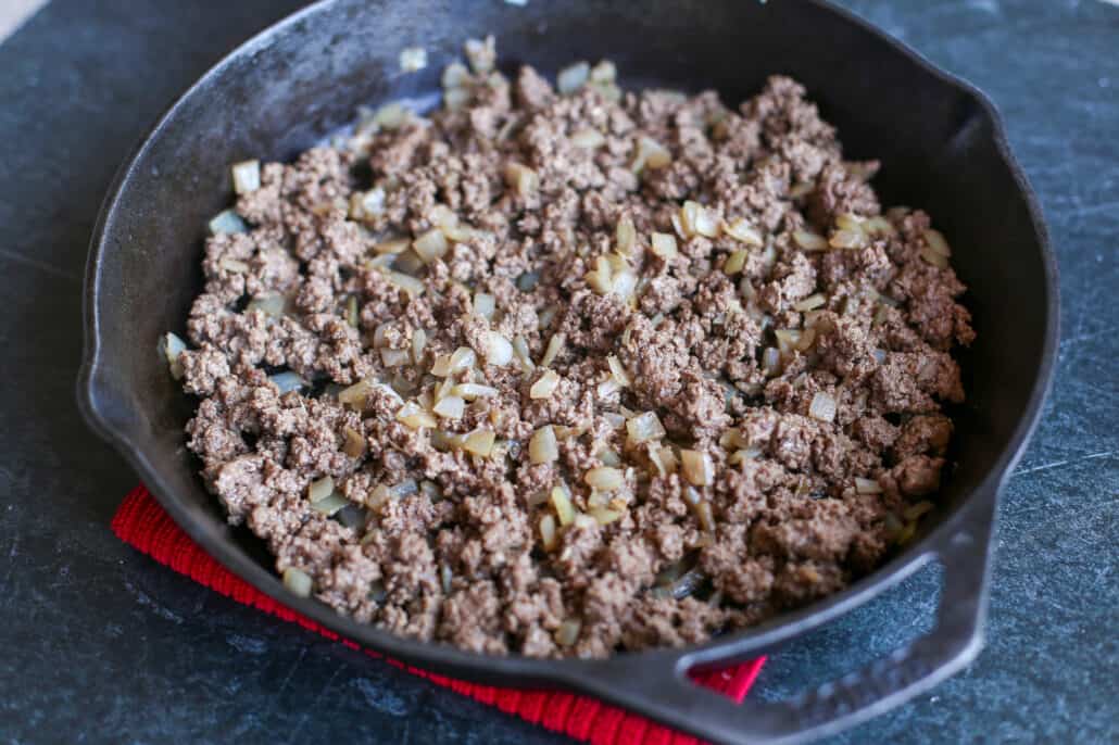 Browning Ground Beef and onion in a cast iron skillet
