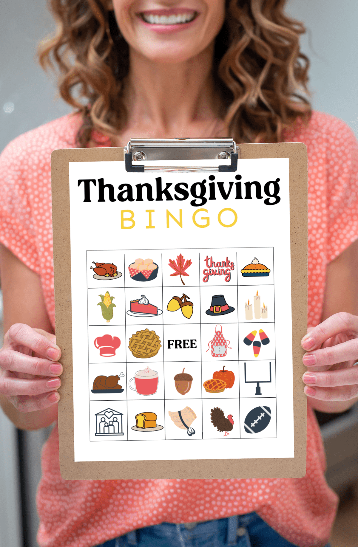 A woman holding a Thanksgiving Bingo sheet on a clipboard. 