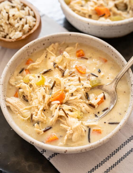 Chicken and wild rice soup in a white bowl with a spoon