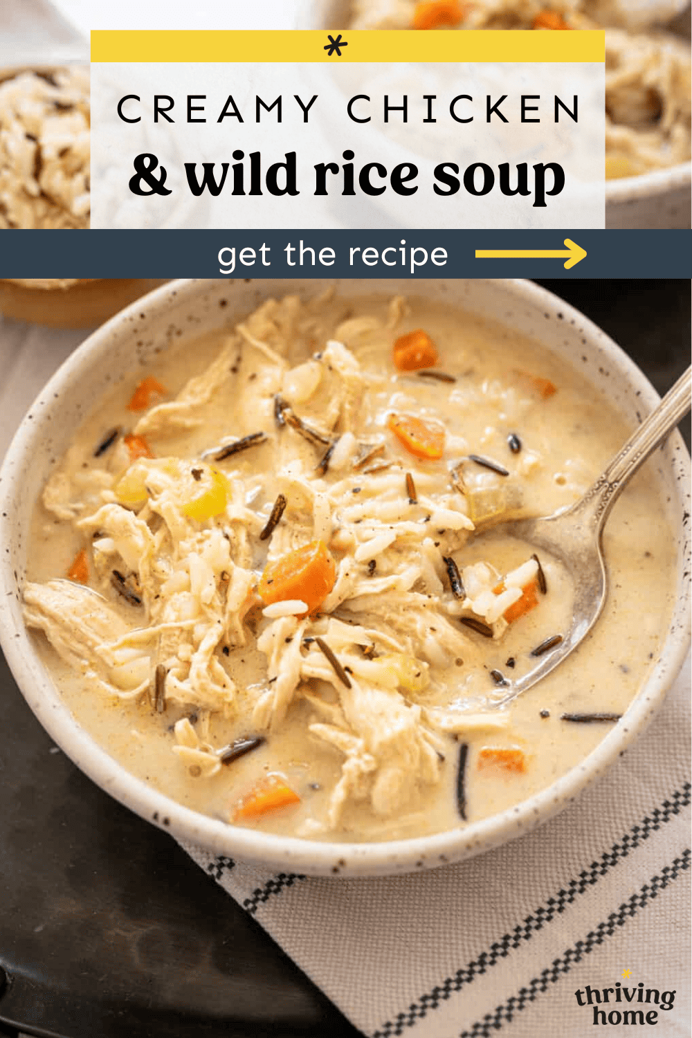Creamy chicken and wild rice soup in a bowl with a spoon.