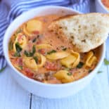 Sausage and tortellini soup in a bowl.