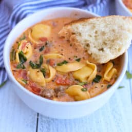 Sausage and tortellini soup in a bowl.