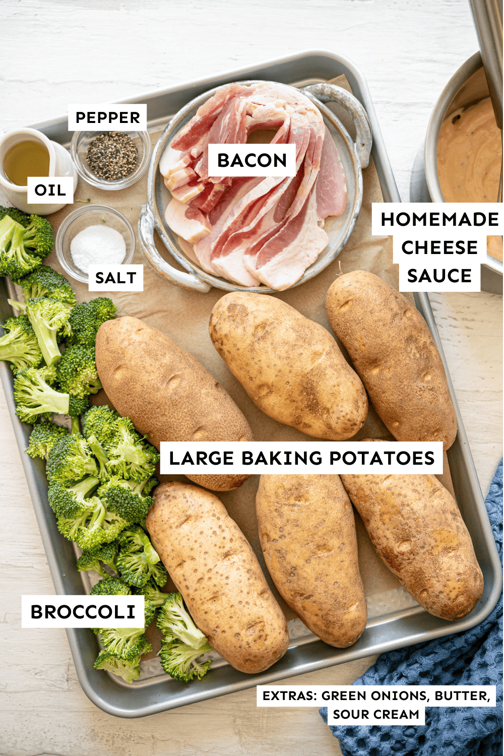 Baked potato bar ingredients laid out on a baking sheet and labeled.
