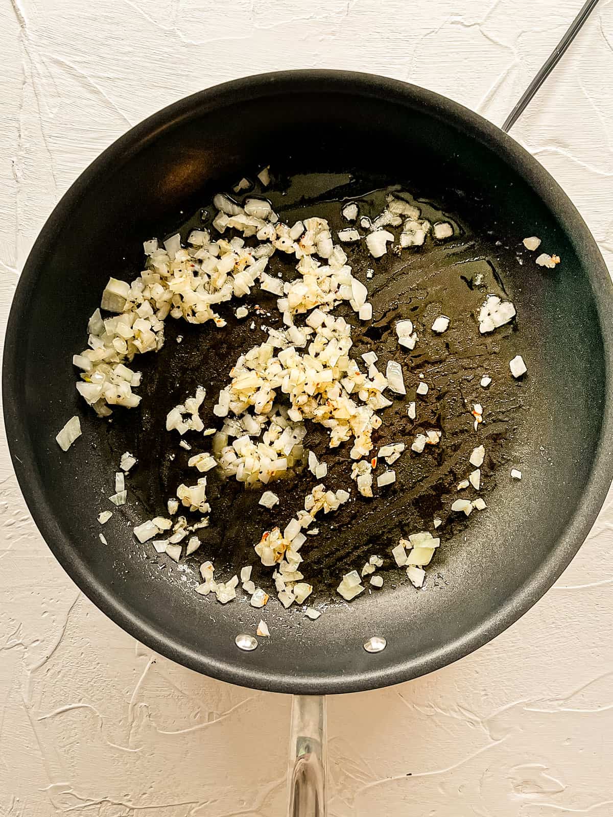 Onions sauting in a pan.