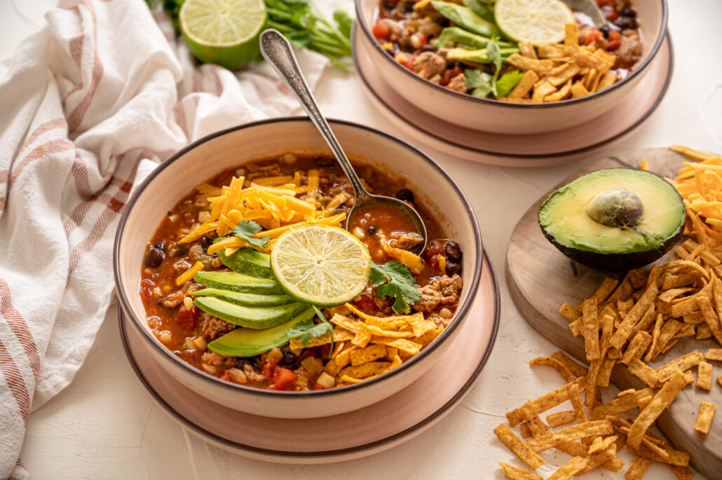 taco soup with toppings in a bowl with a spoon