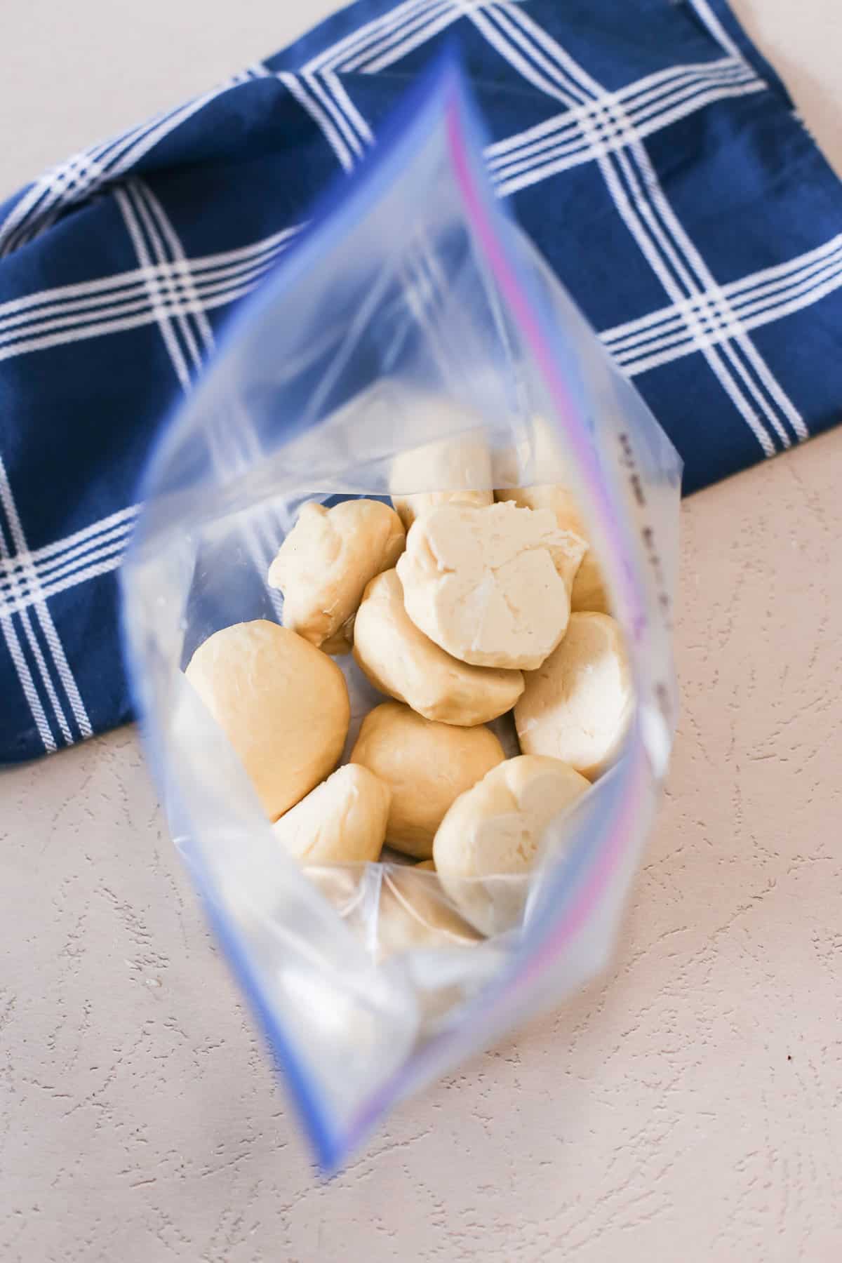 Flash frozen, unbaked dinner rolls inside a freezer bag.