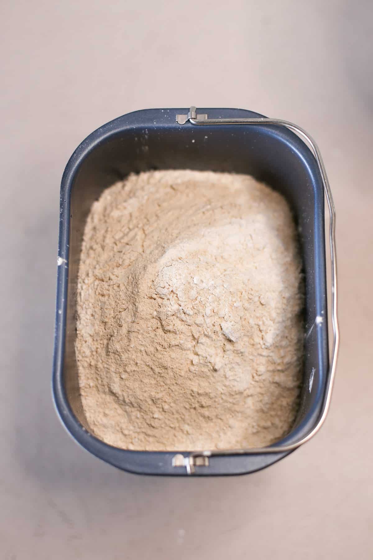 Dry ingredients in bread machine insert.