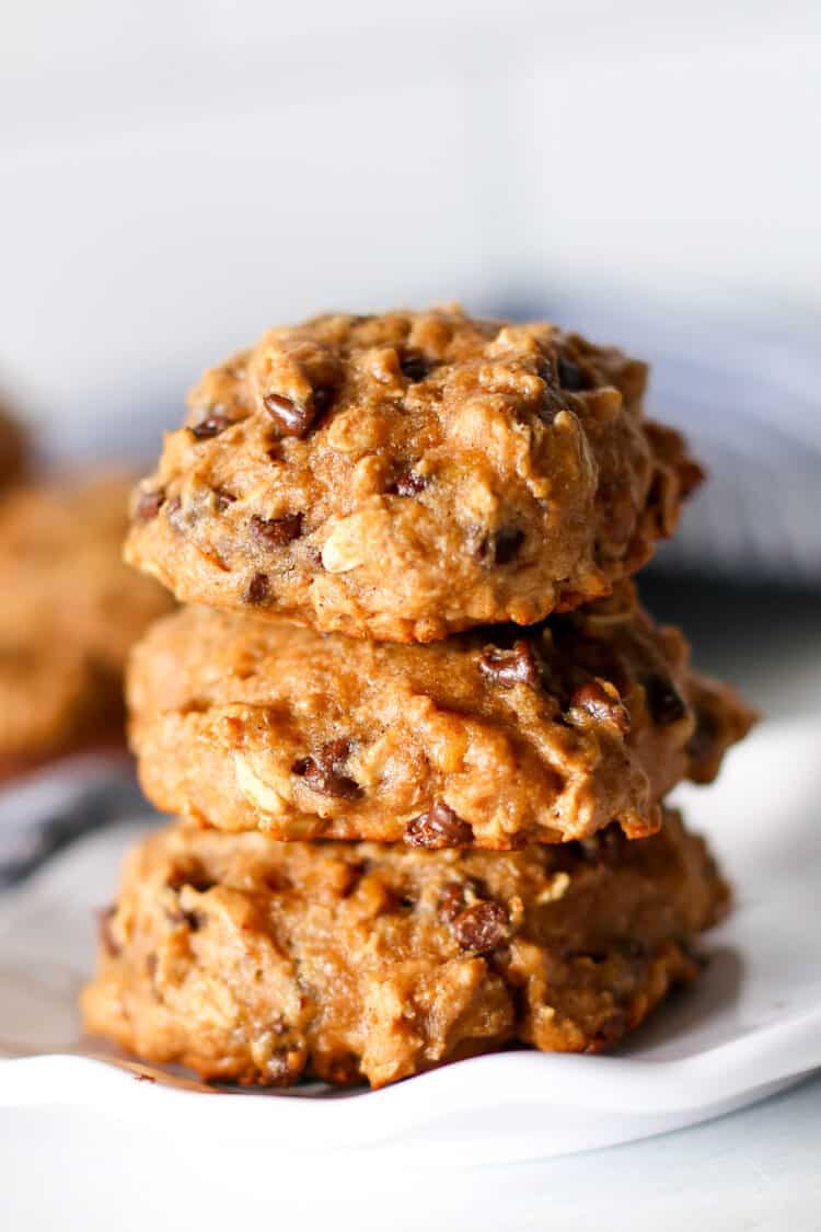 Three breakfast cookies stacked up on a plate.