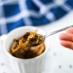 A spoonful of chocolate mug cake being lifted from the mug.