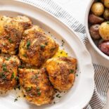 Italian Baked Chicken Thighs on a white platter.