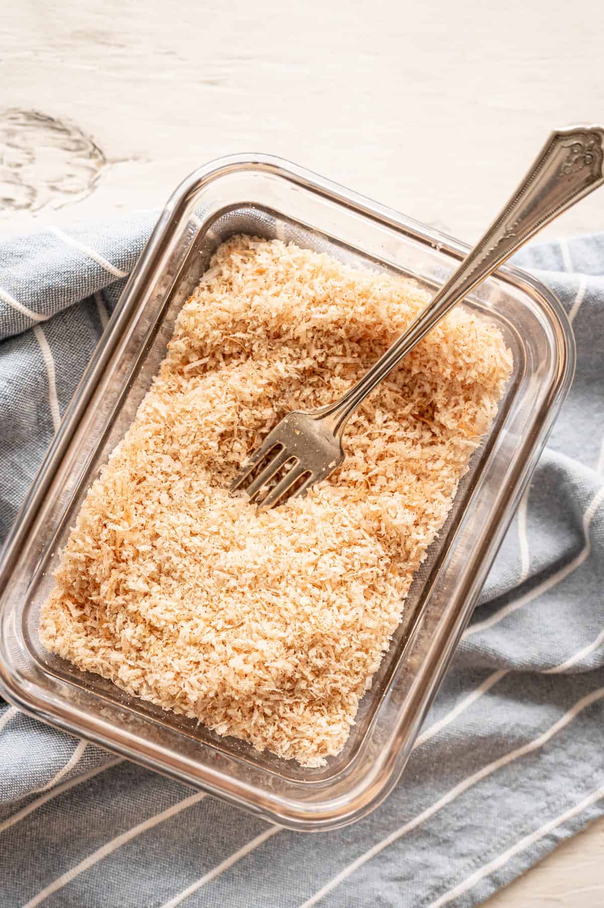 Breadcrumb coating mixture in a dish with a fork.