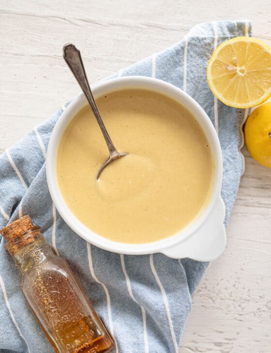 overhead shot of honey mustard dipping sauce in bowl with spoon
