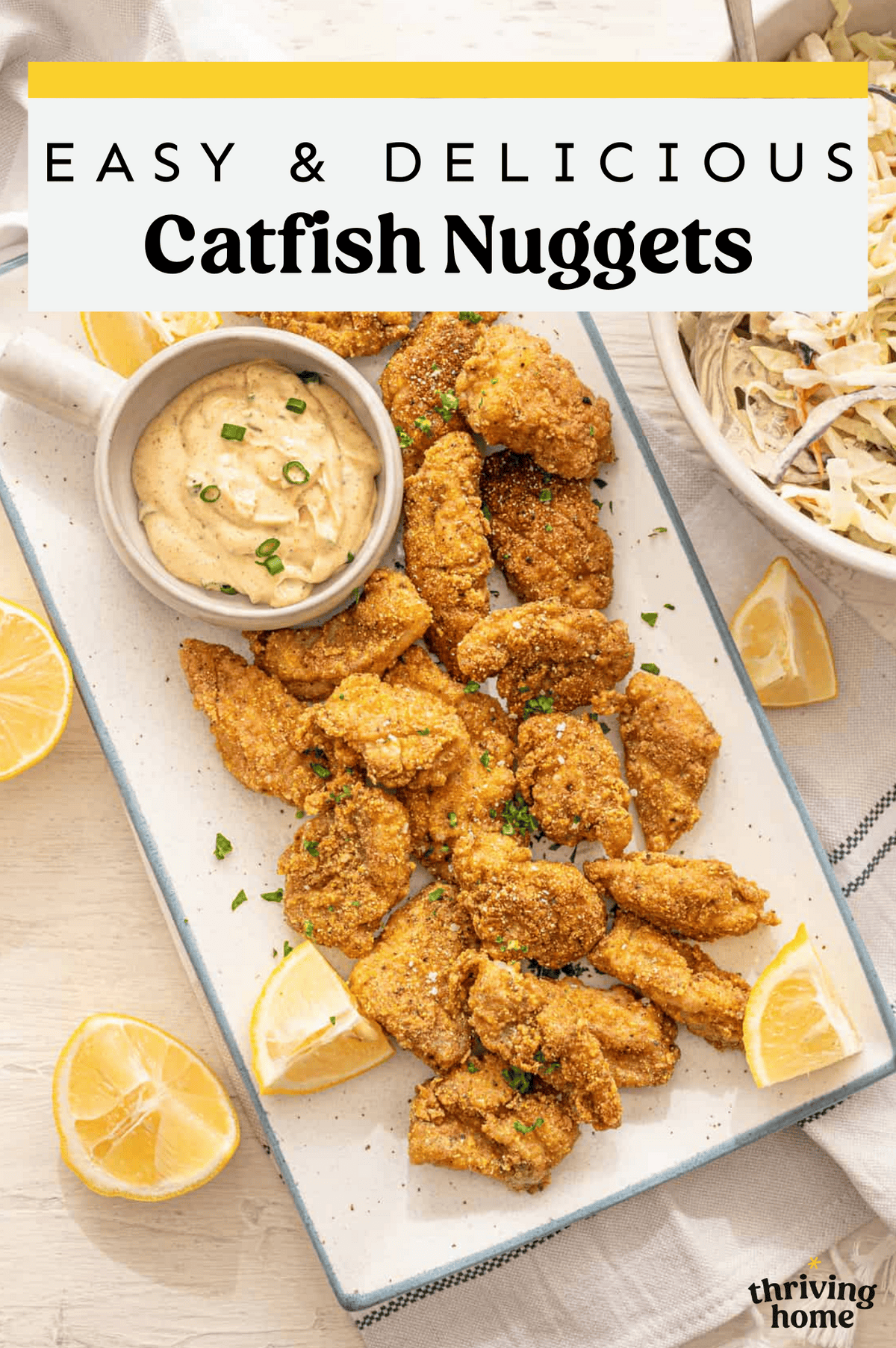 Catfish nuggets on a tray with dipping sauce.