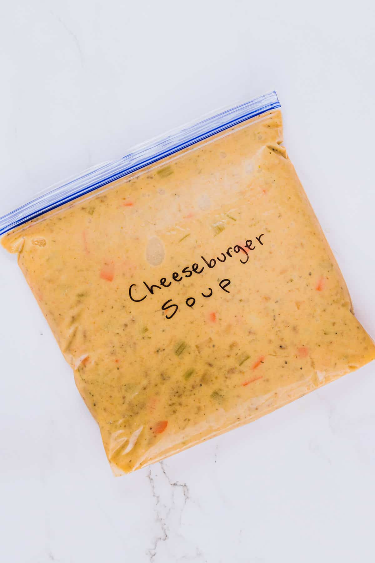 A full gallon-size freezer bag labeled Cheeseburger Soup.