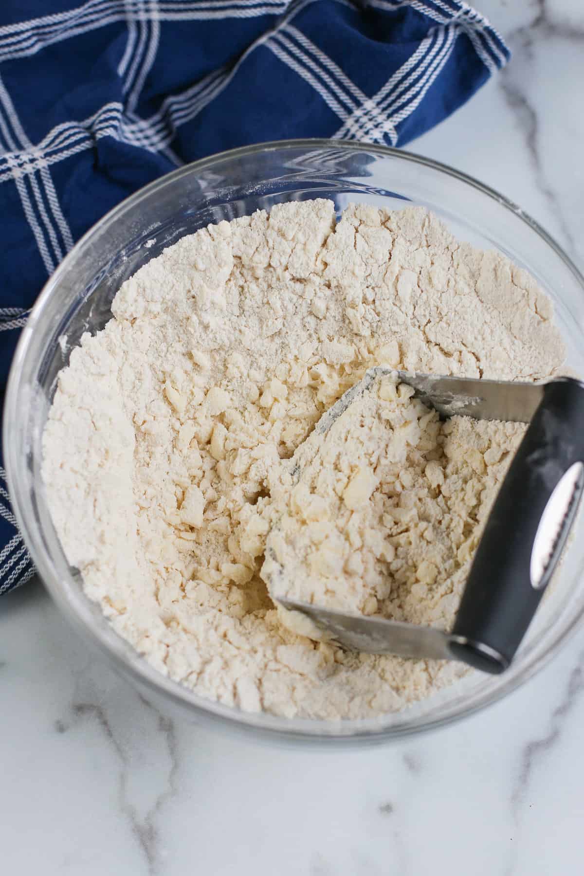 making the crust for lemon bars in a glass bowl
